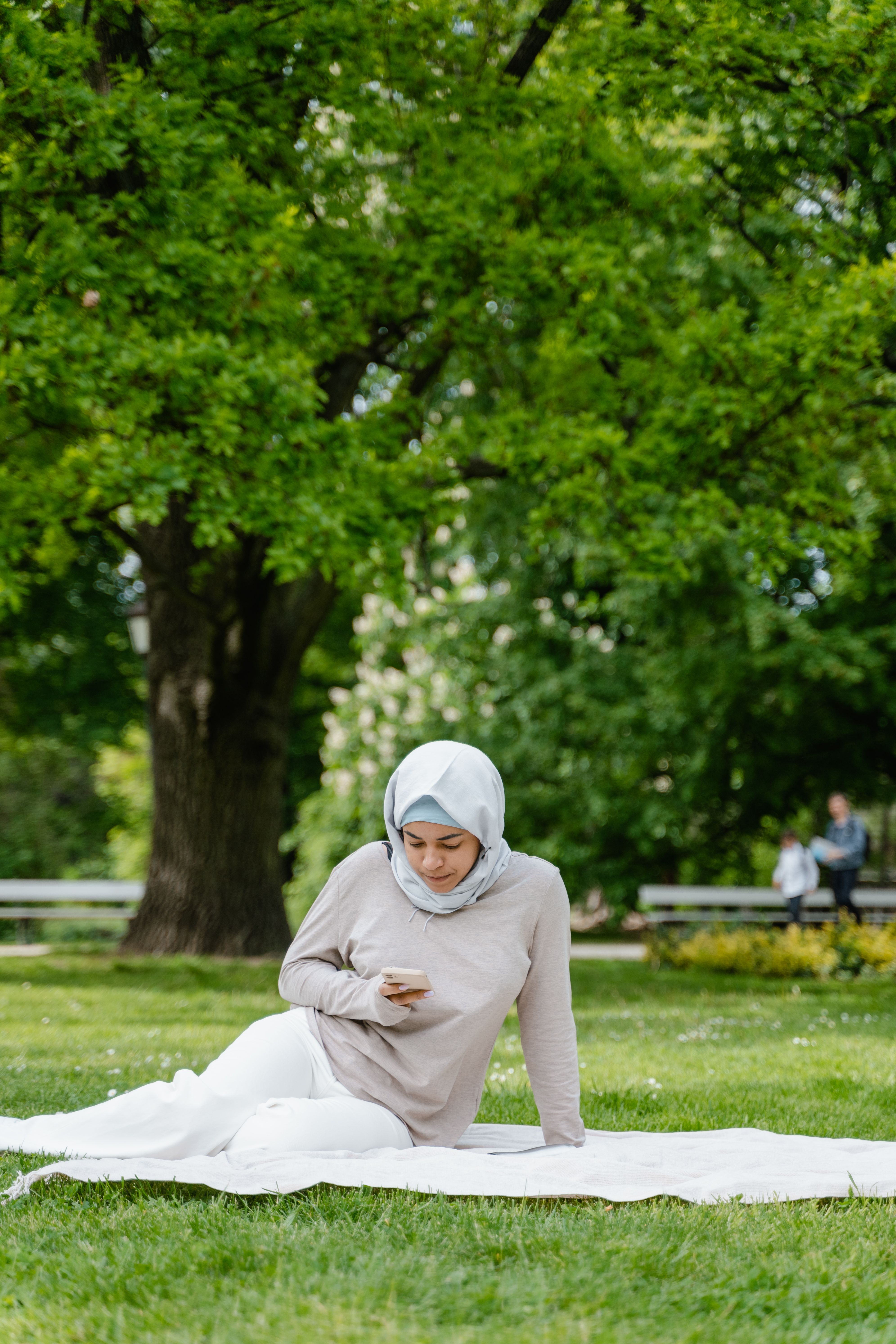 Woman in White Hijab Sitting on the Park · Free Stock Photo