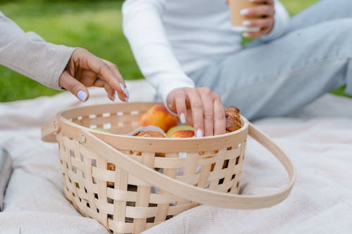 A Person Grabbing Food from a Basket