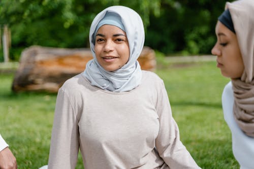 Close-Up Photo of Woman Wearing Hijab Sitting on a Park