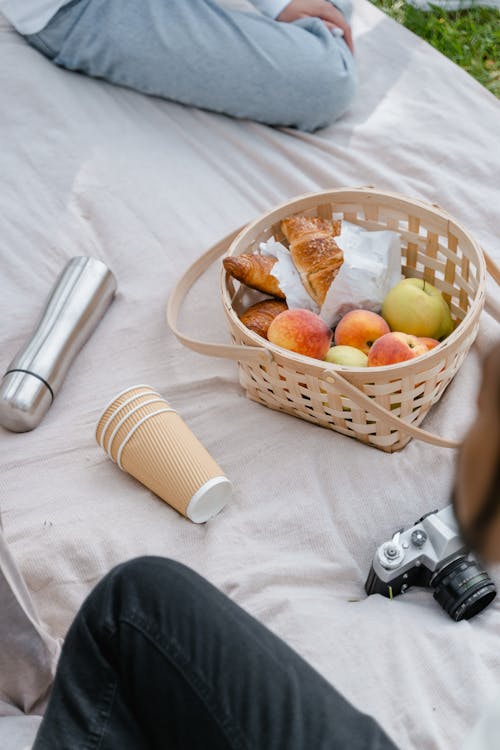 Basket with Bread and Fruits on Picnic Blanket