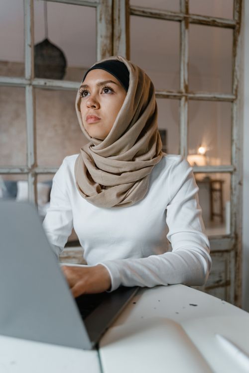 Woman in White Long Sleeve Shirt Wearing Brown Hijab Looking Afar ...