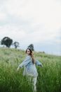 Woman in Blue Denim Jacket Standing on Green Grass Field