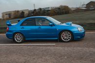 Blue Sedan on Brown Dirt Road