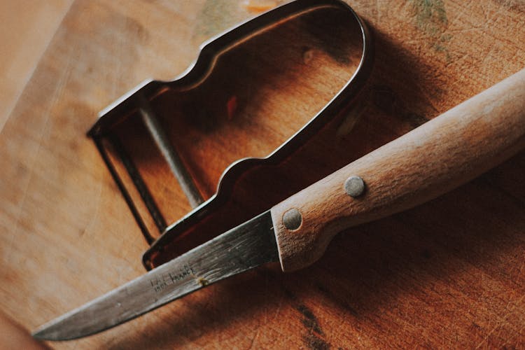 Close-up Shot Of A Knife And Peeler On The Table