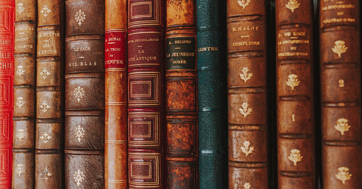 Close-up of vintage leather-bound books showcasing ornate spines.