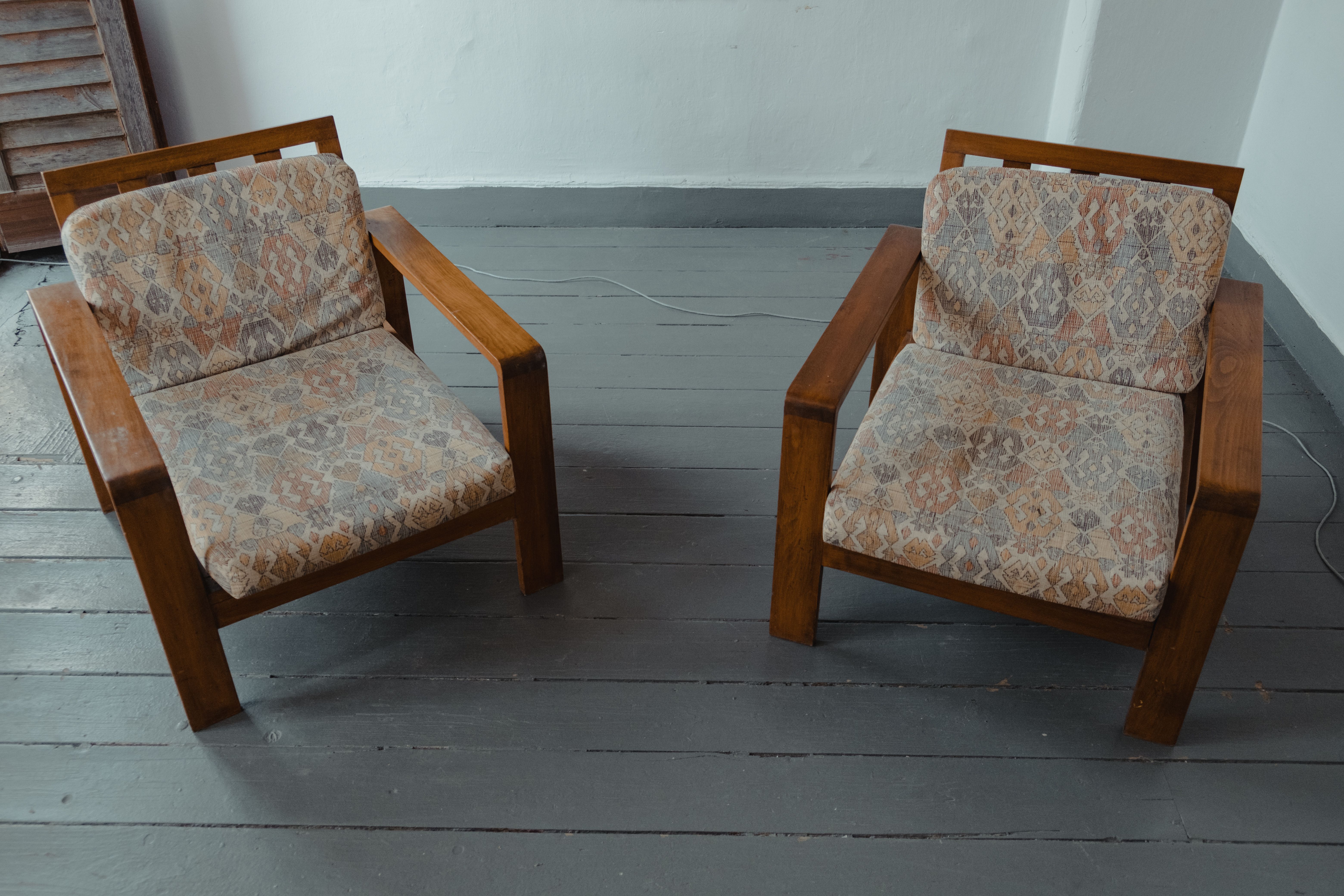 Two chairs facing each other in a quiet room, set up for a coaching conversation