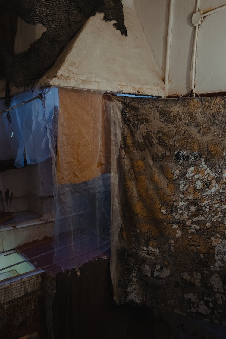 Fabrics Hanging In Shabby Interior