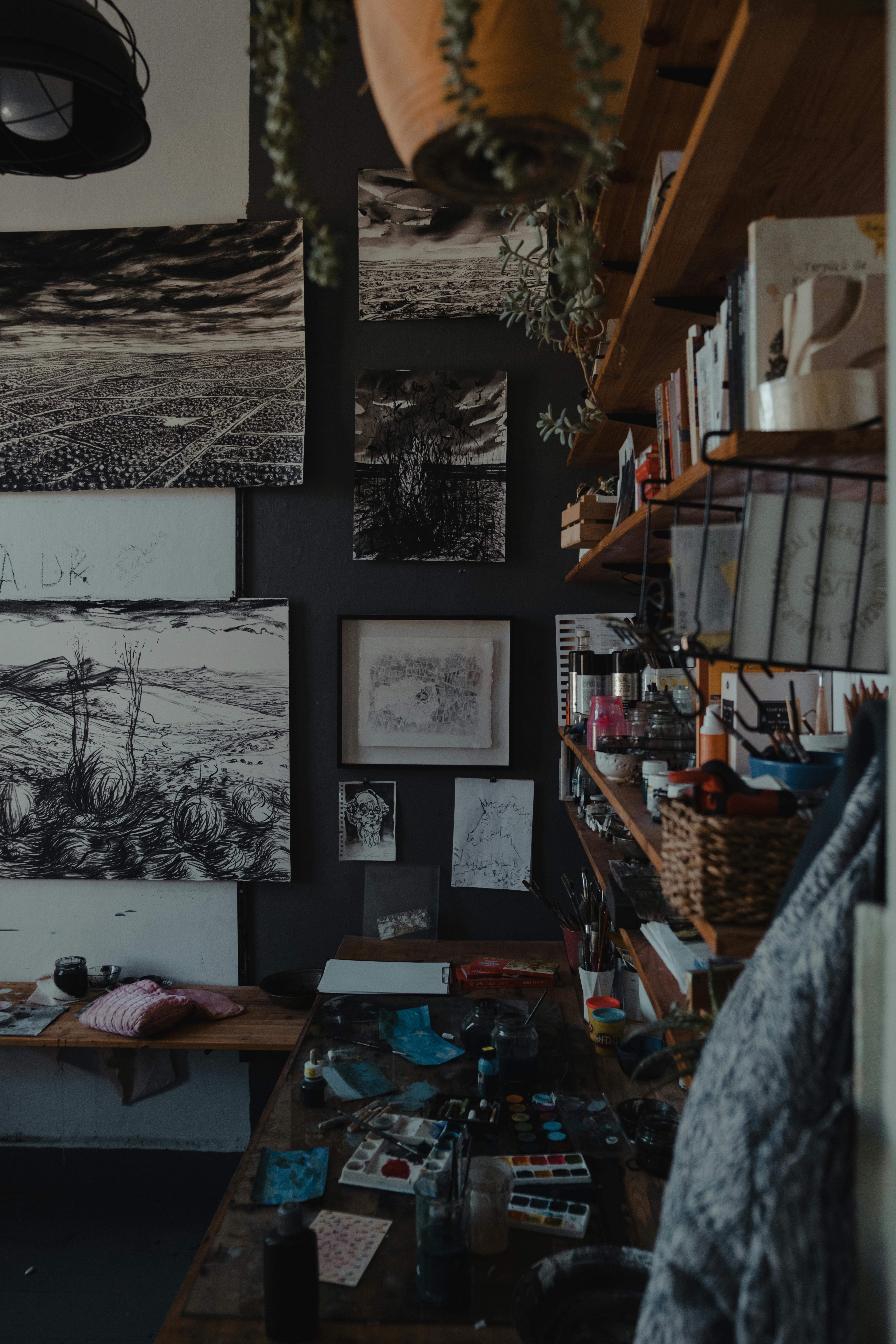Art studio featuring detailed sketches, shelves with art supplies, and a creative work space.