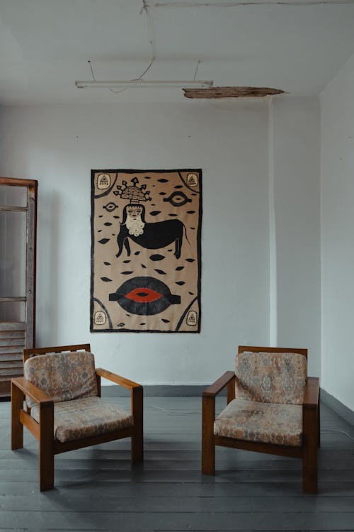 Two Retro Armchairs in an Empty Room with a Abstract Painting on the Wall 