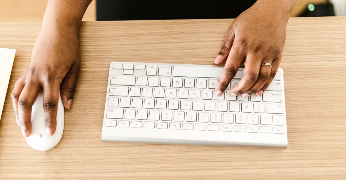 Photo of a Person Holding a White Computer Mouse while Typing · Free ...