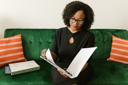 Woman Wearing Eyeglasses Holding a Paper