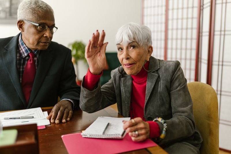 Two senior colleagues engaged in discussion