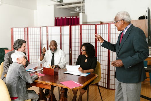 Group of colleagues in discussion during a business meeting in an office.