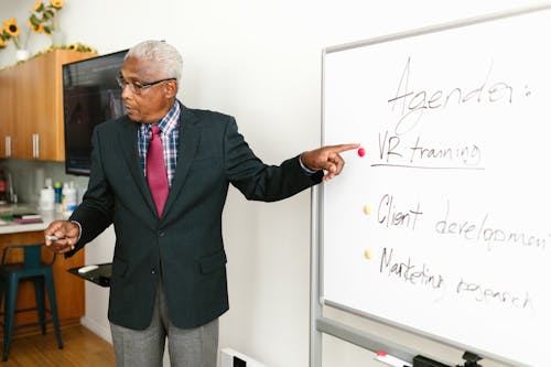 Free An Elderly Man Discussing while using Whiteboard Stock Photo