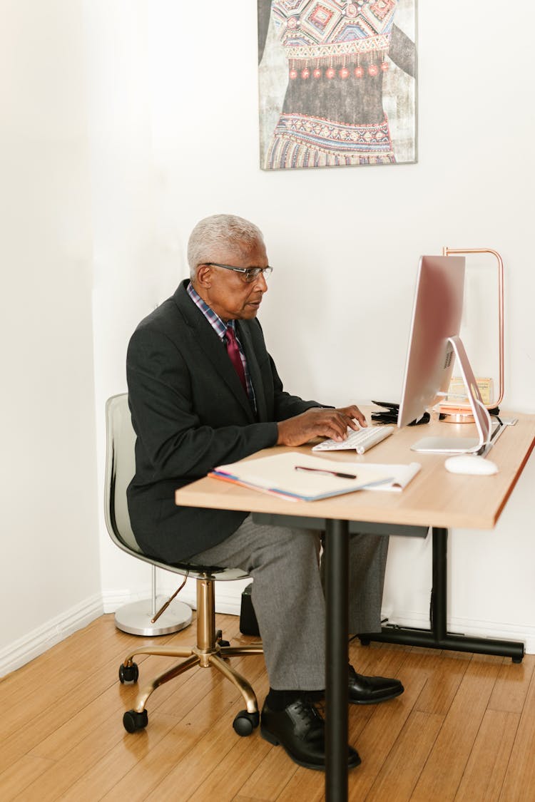 Elderly Man Working At The Office