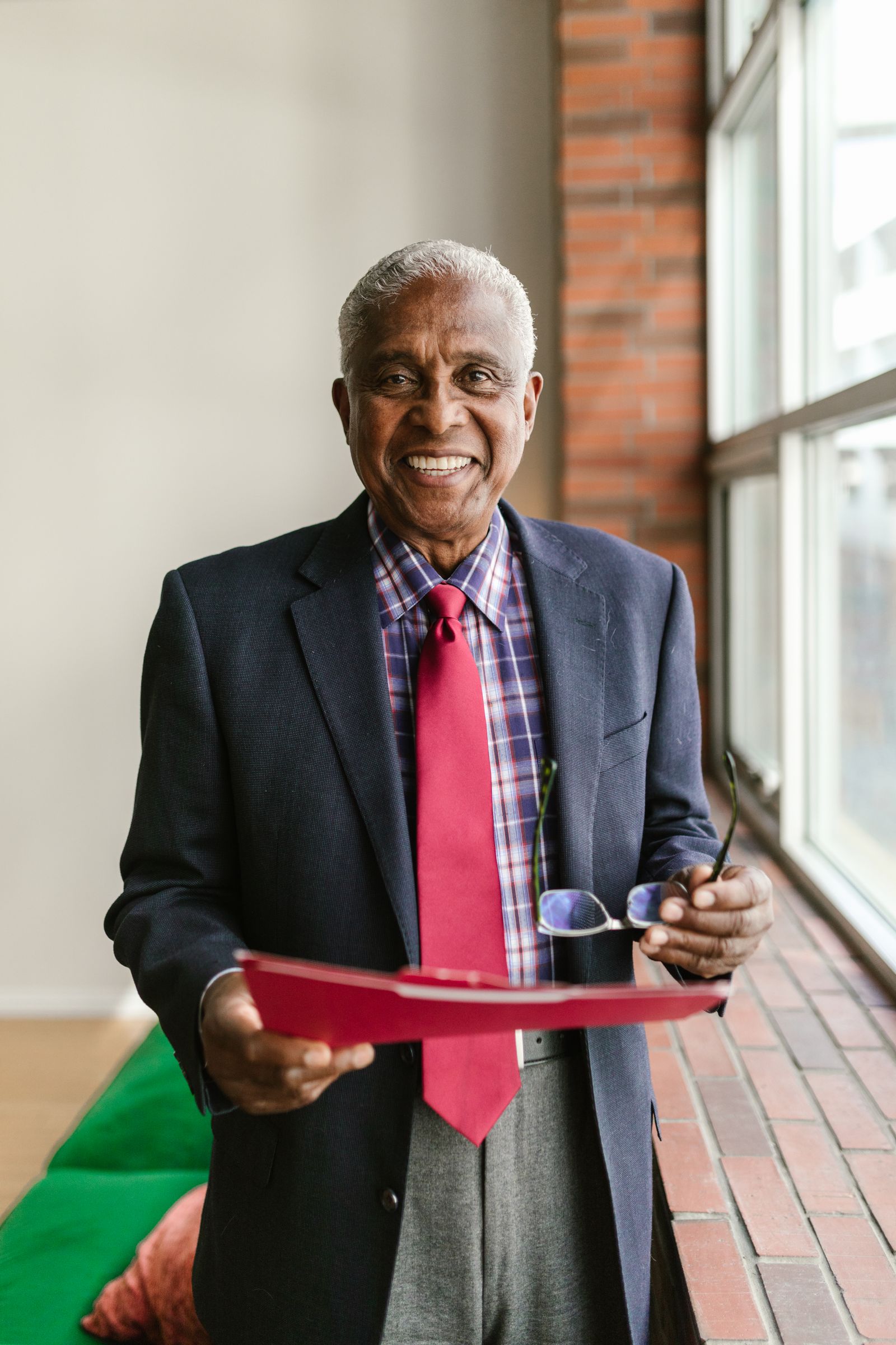 A senior director in a suit standing in an office