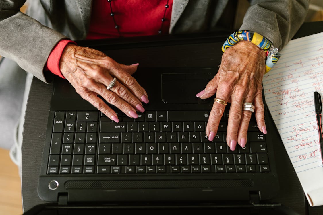 Free A Person Typing on Laptop Stock Photo
