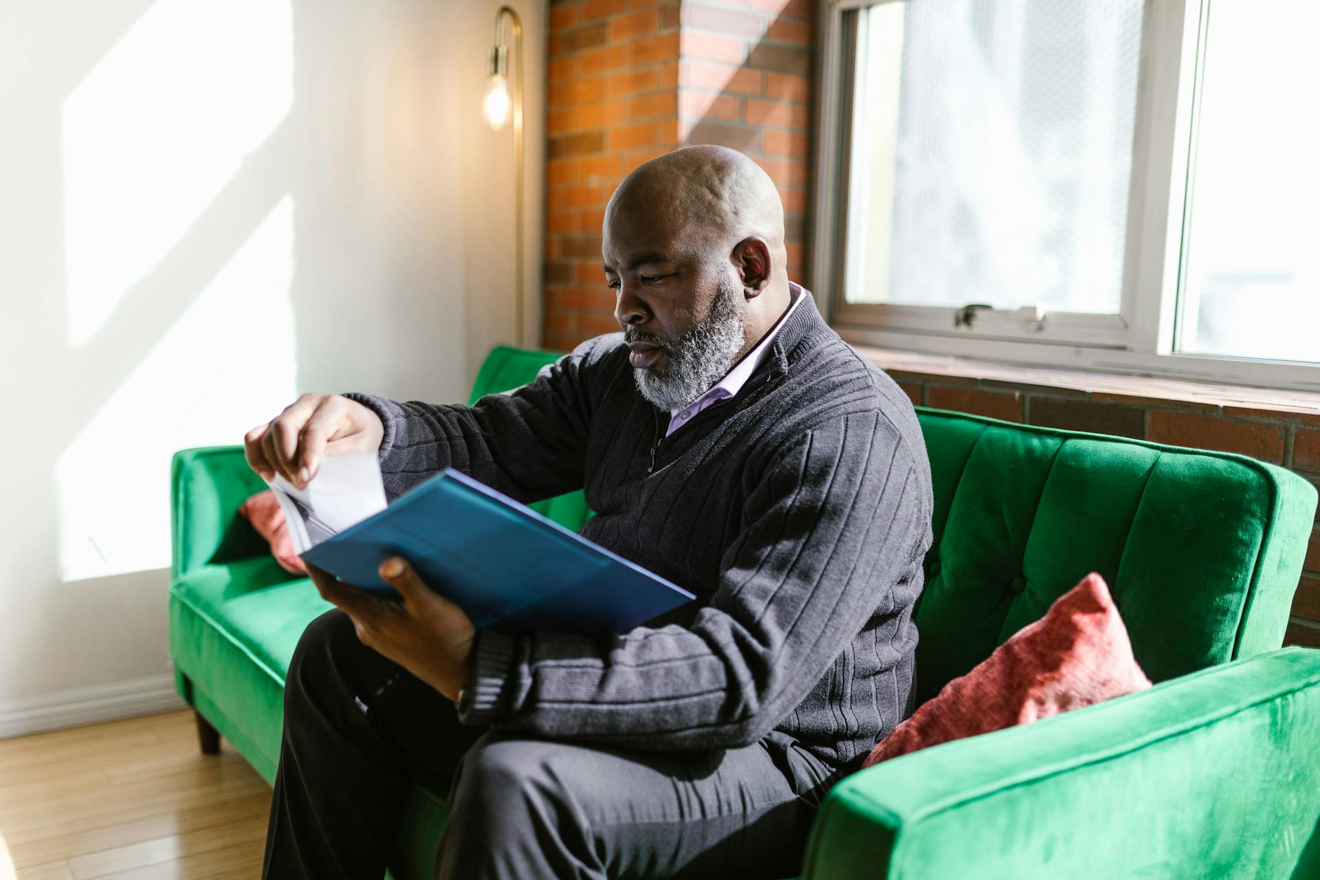 Bald Man with Serious Face Looking at the Papers in the Folder