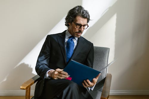 Businessman Sitting and Reading