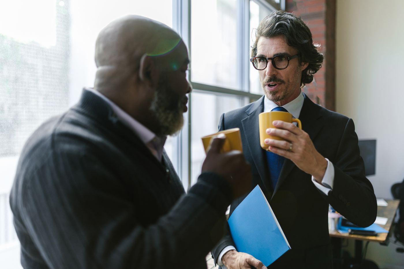 Two colleagues talking over coffee