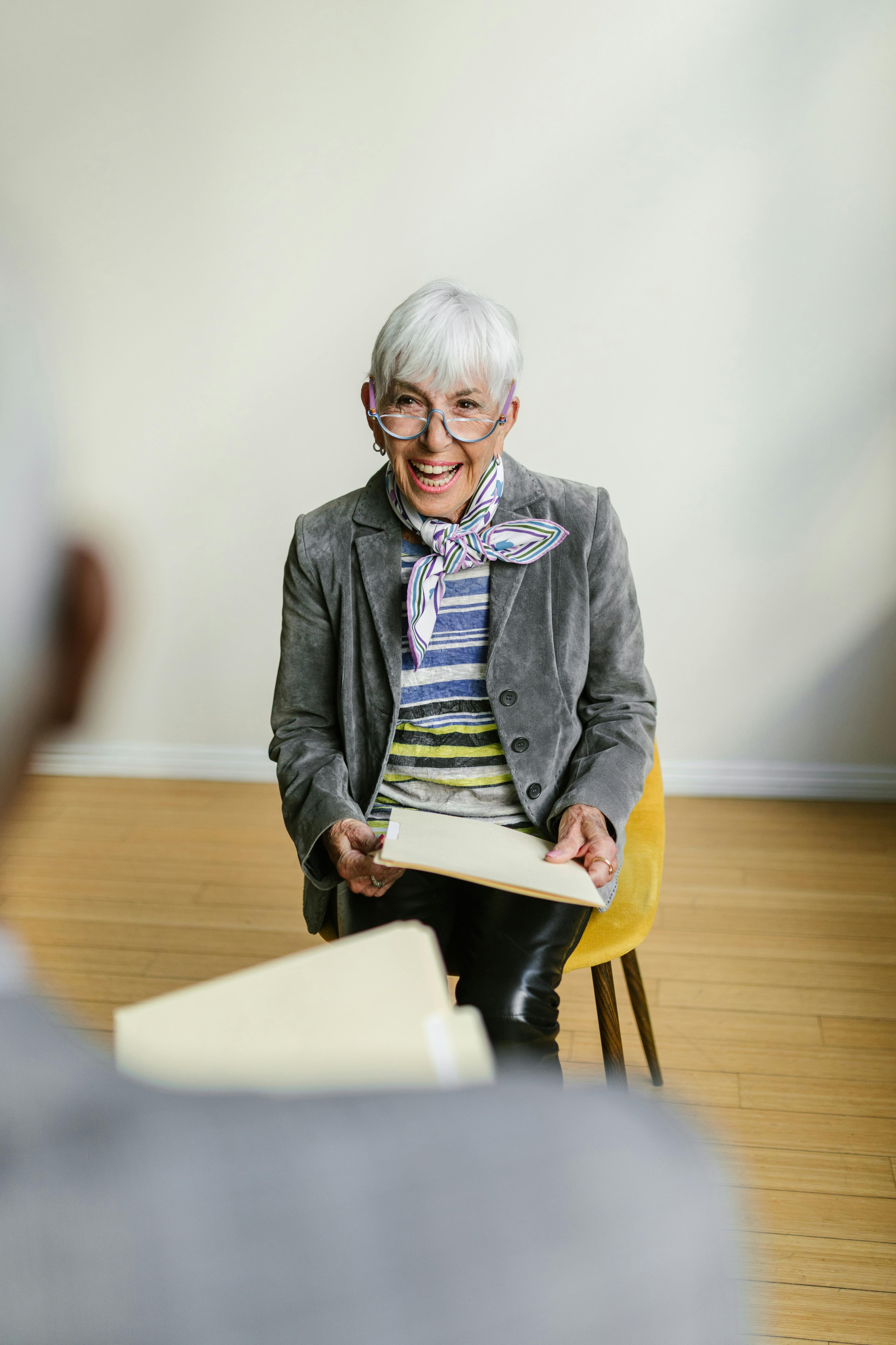 a woman in gray blazer sitting on a chair