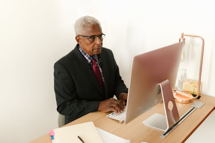 Man In Corporate Attire Using A Computer