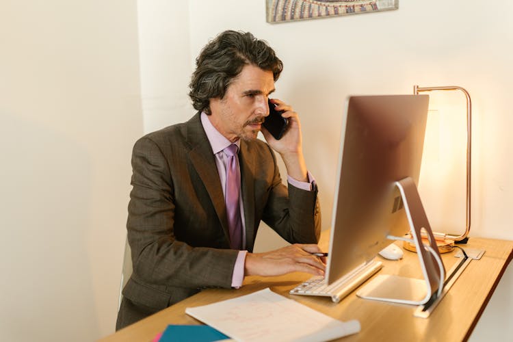 A Man Using A Computer 