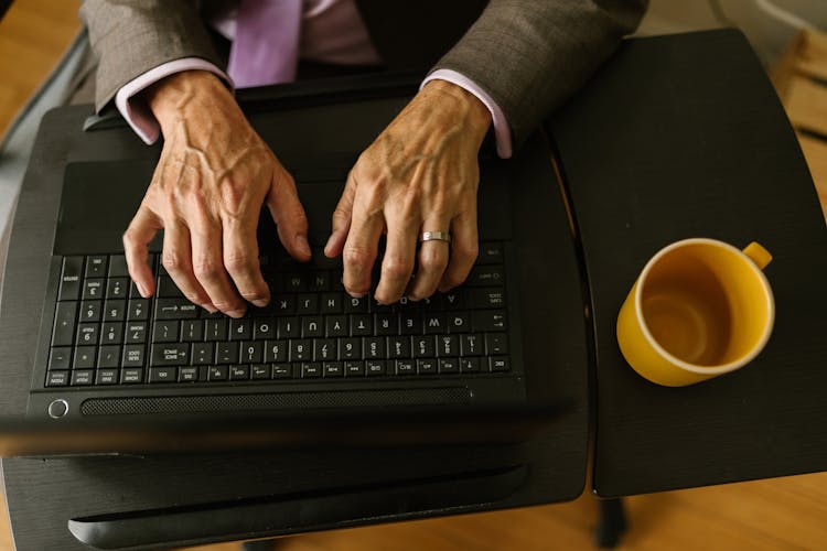 Person Typing On Black Laptop Computer