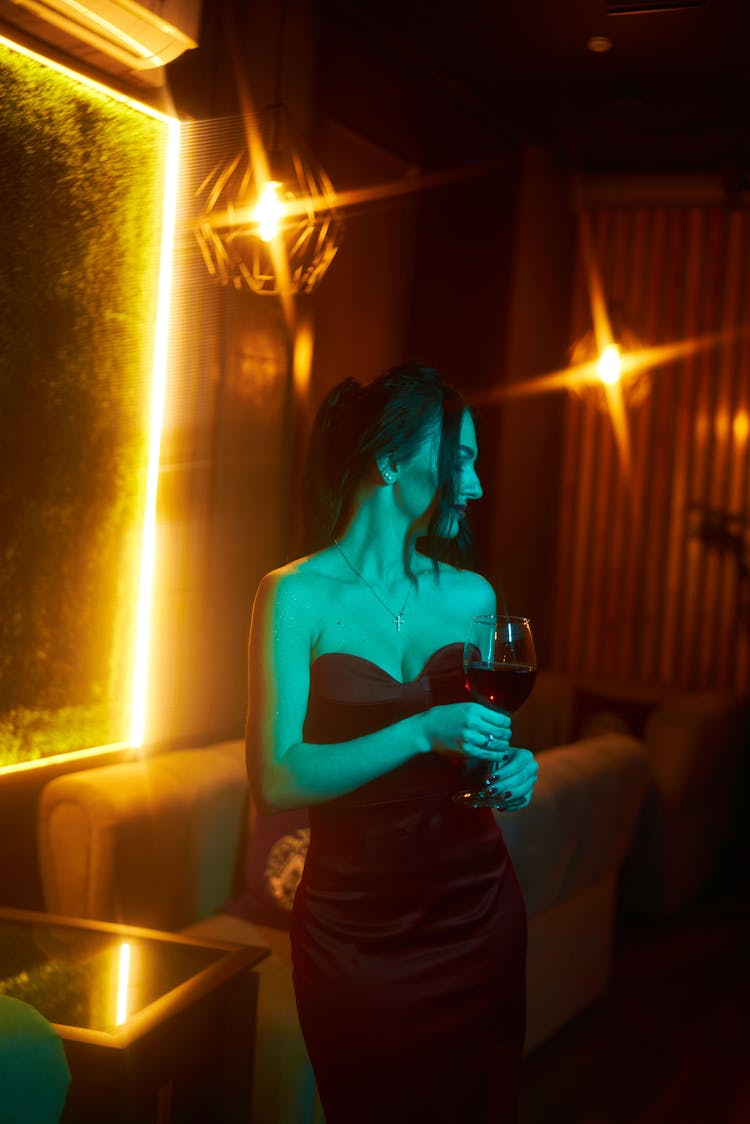 Young Woman With Wine In Restaurant