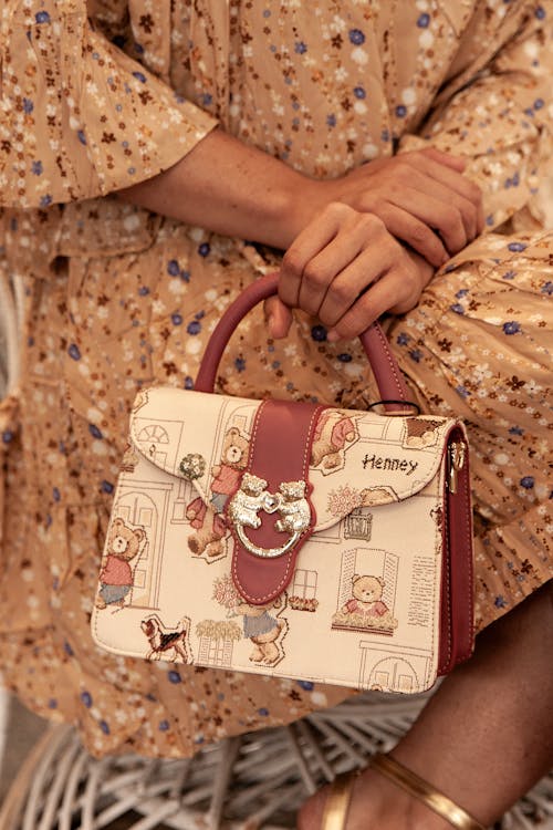 Woman in Floral Dress Holding Leather Handbag with Teddy Bears
