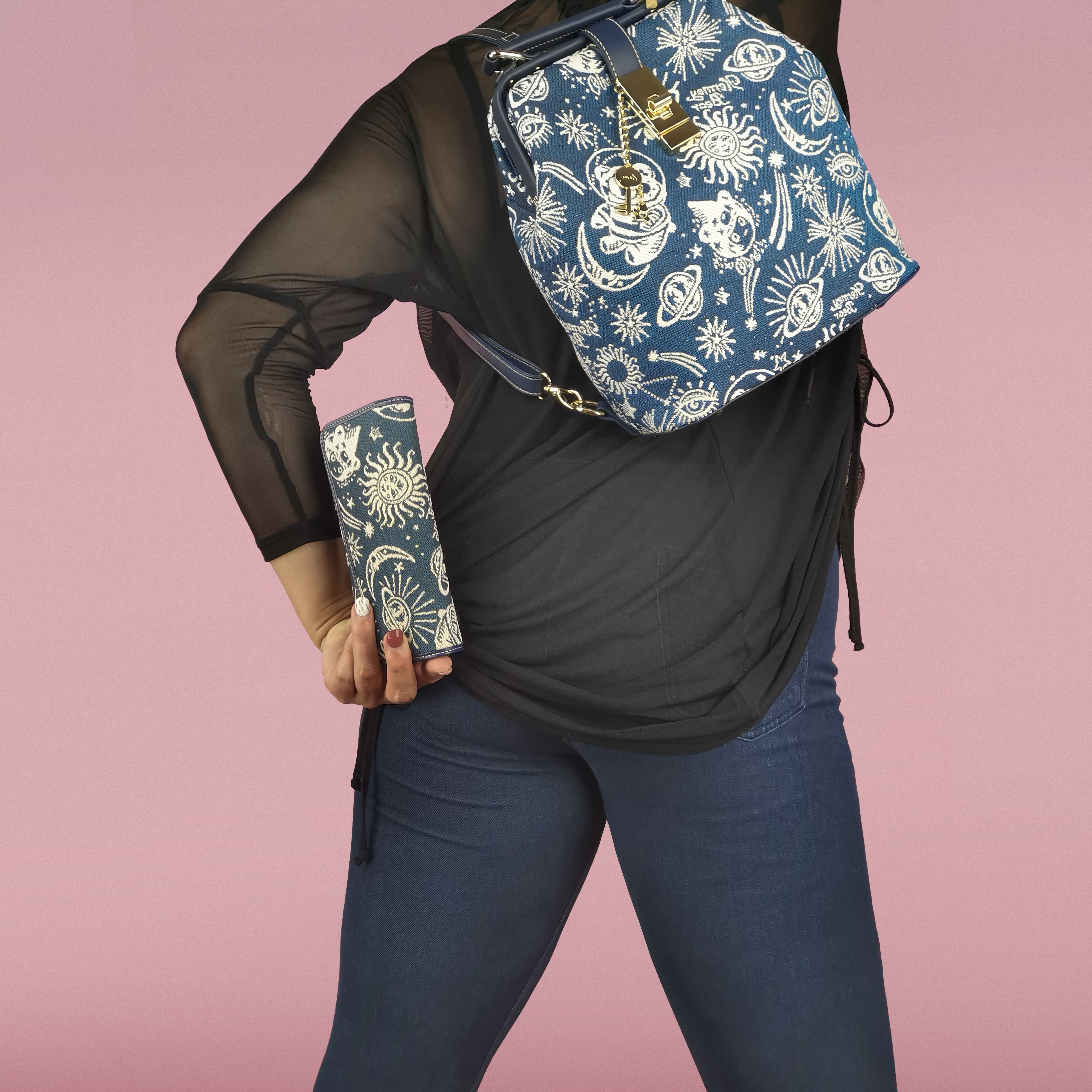 Woman Showing off Backpack and Purse with Space Themed Pattern