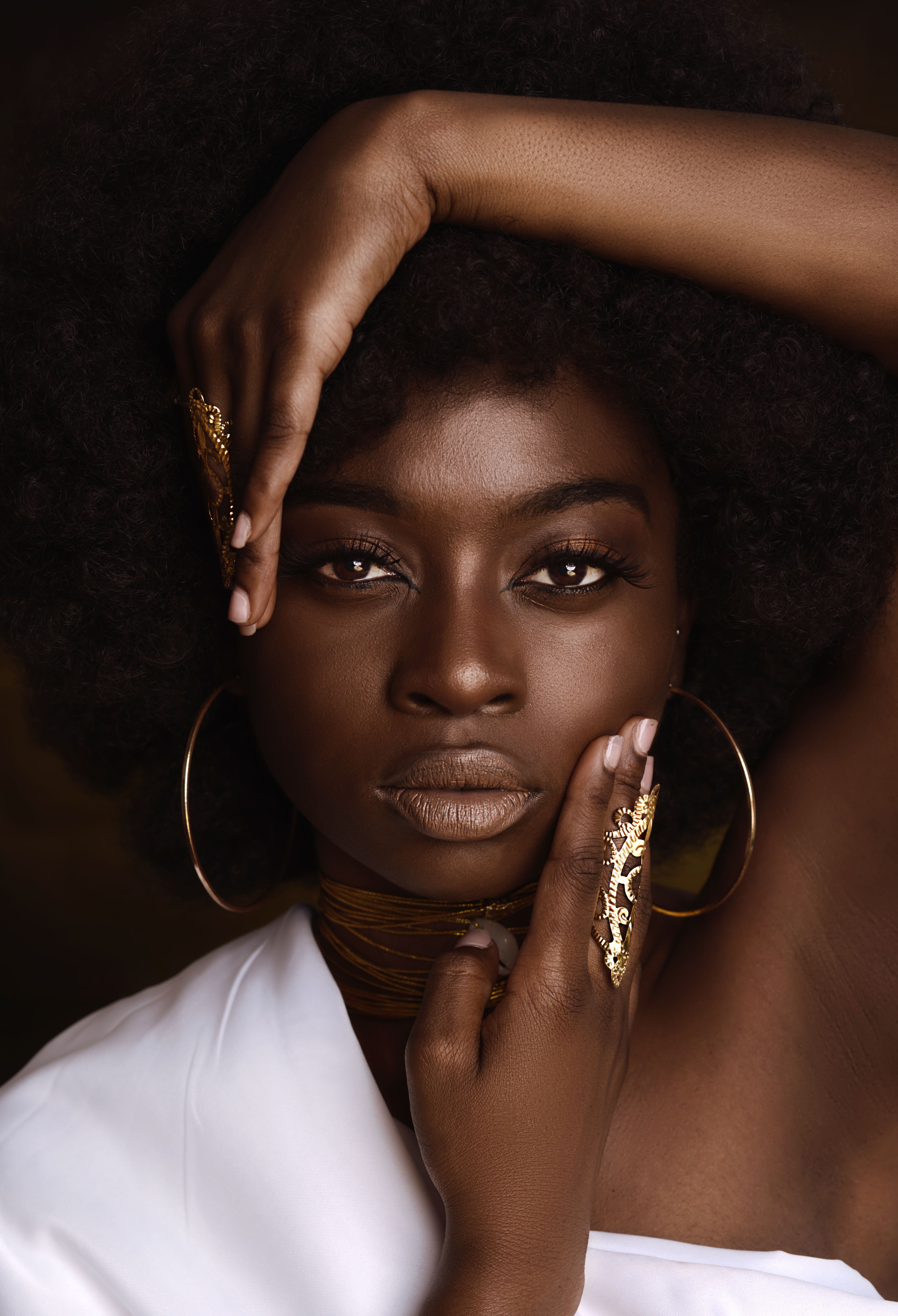 A Beautiful Woman with Her Hands on Her Face · Free Stock Photo