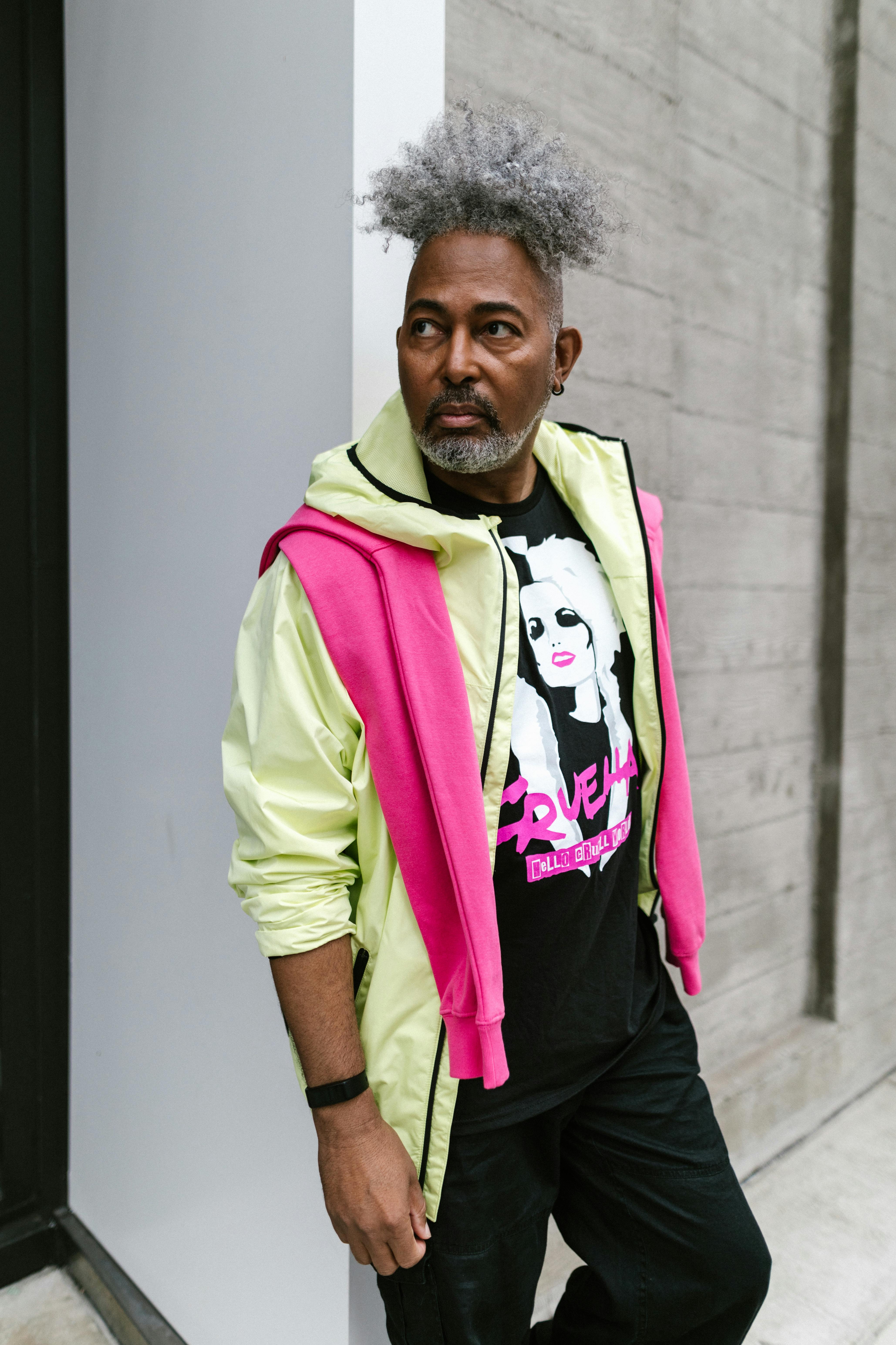 a man with grey afro hair while posing