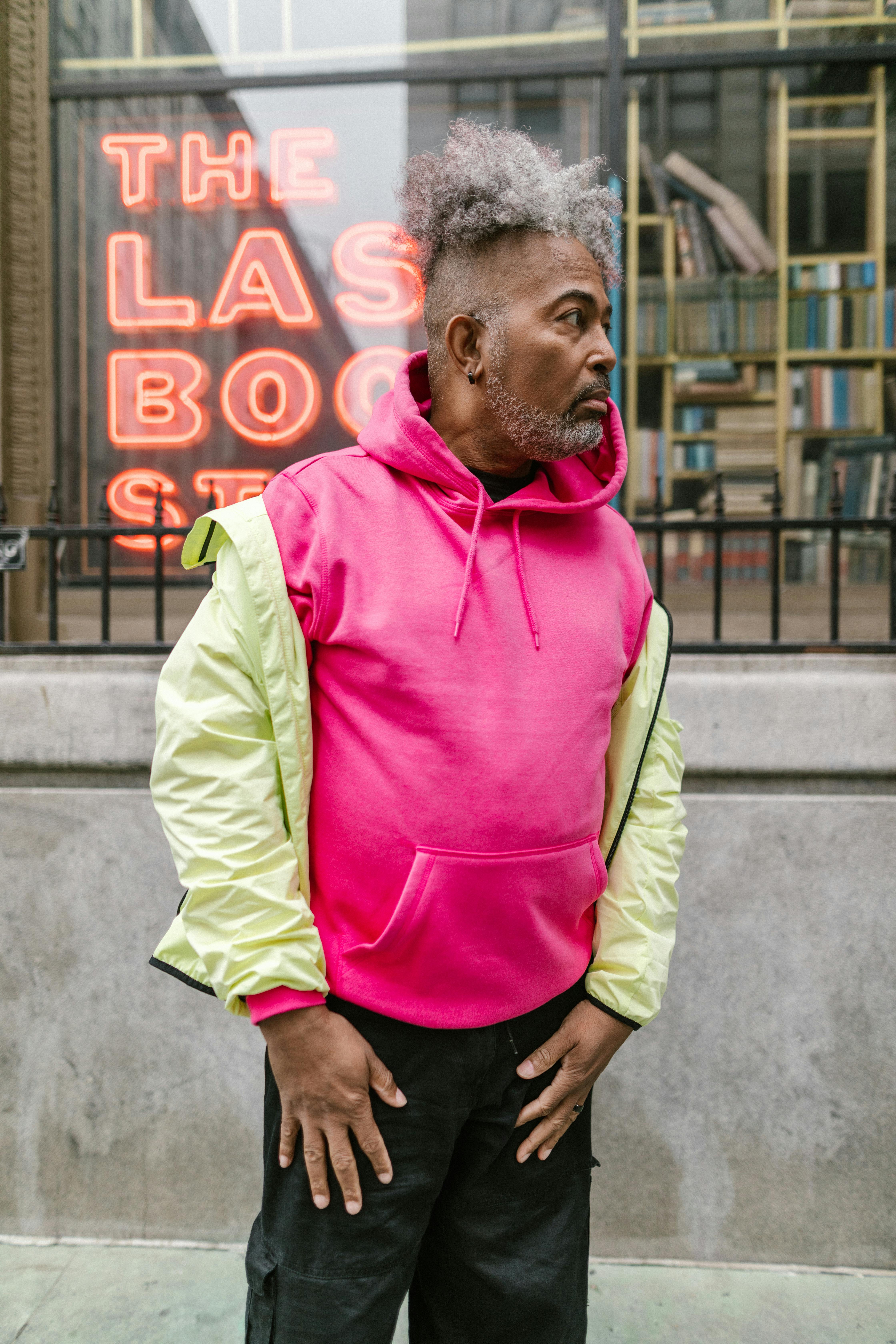 Gray Haired Man Wearing Neon Pink Hoodie Sweater Free Stock Photo