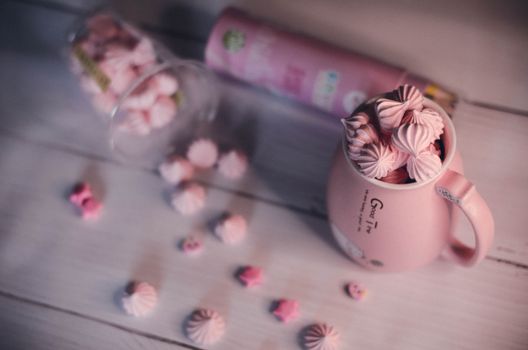 Sweet pink meringues in a stylish coffee mug, perfect for dessert lovers.
