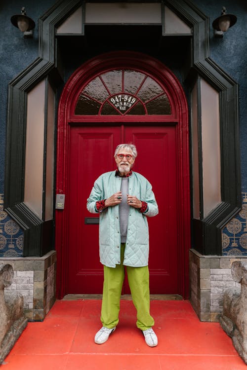 Elderly Man in Front of Red Door 