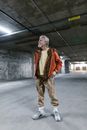 Man in Red and White Scarf and Gray Pants Standing