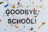 Colorful confetti surrounds a goodbye school message, celebrating graduation.