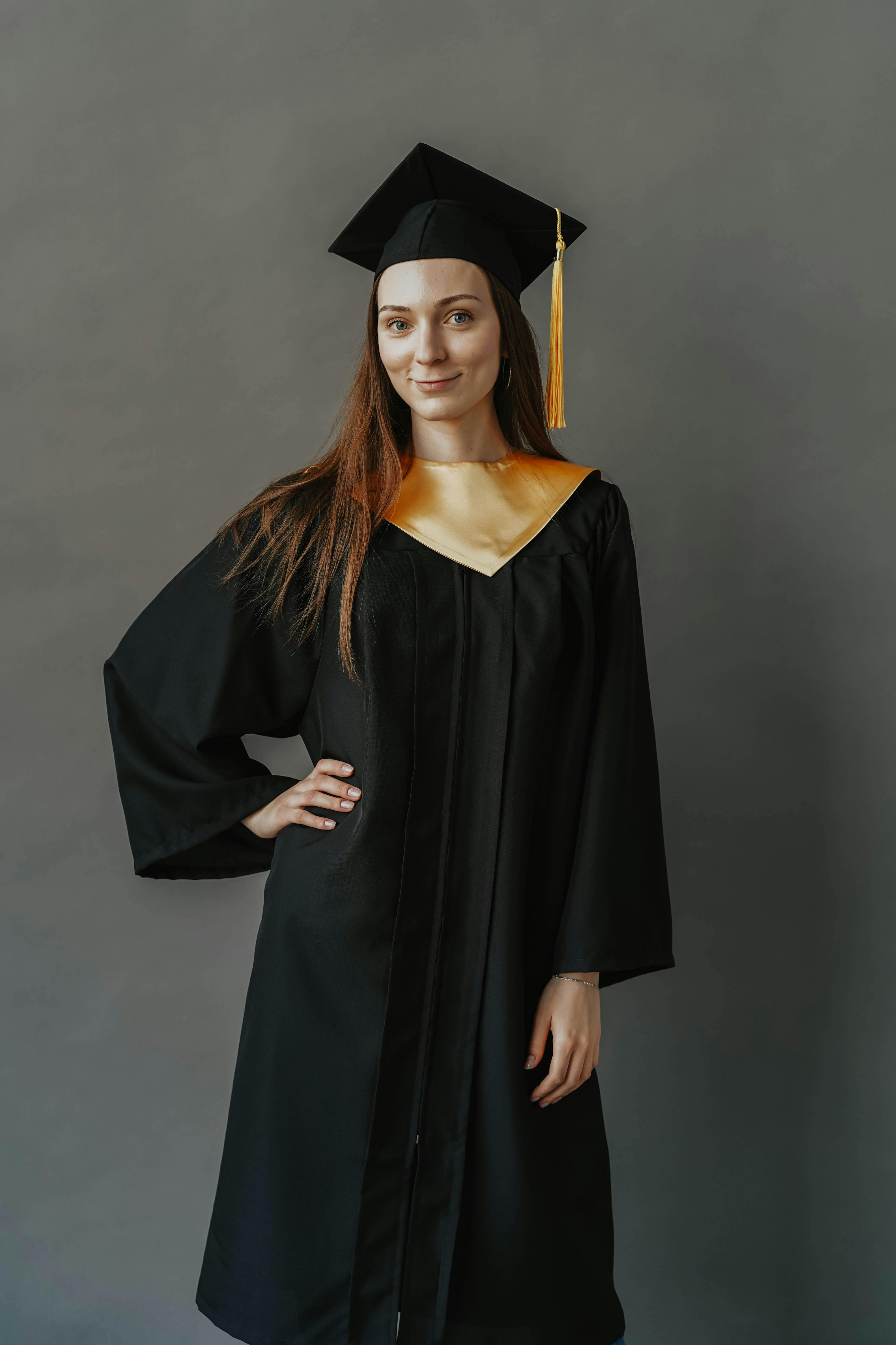 A Person Holding a Black Graduation Hat · Free Stock Photo