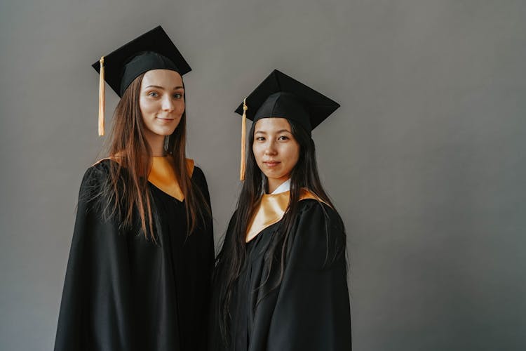 Photograph Of Women With Graduation Caps
