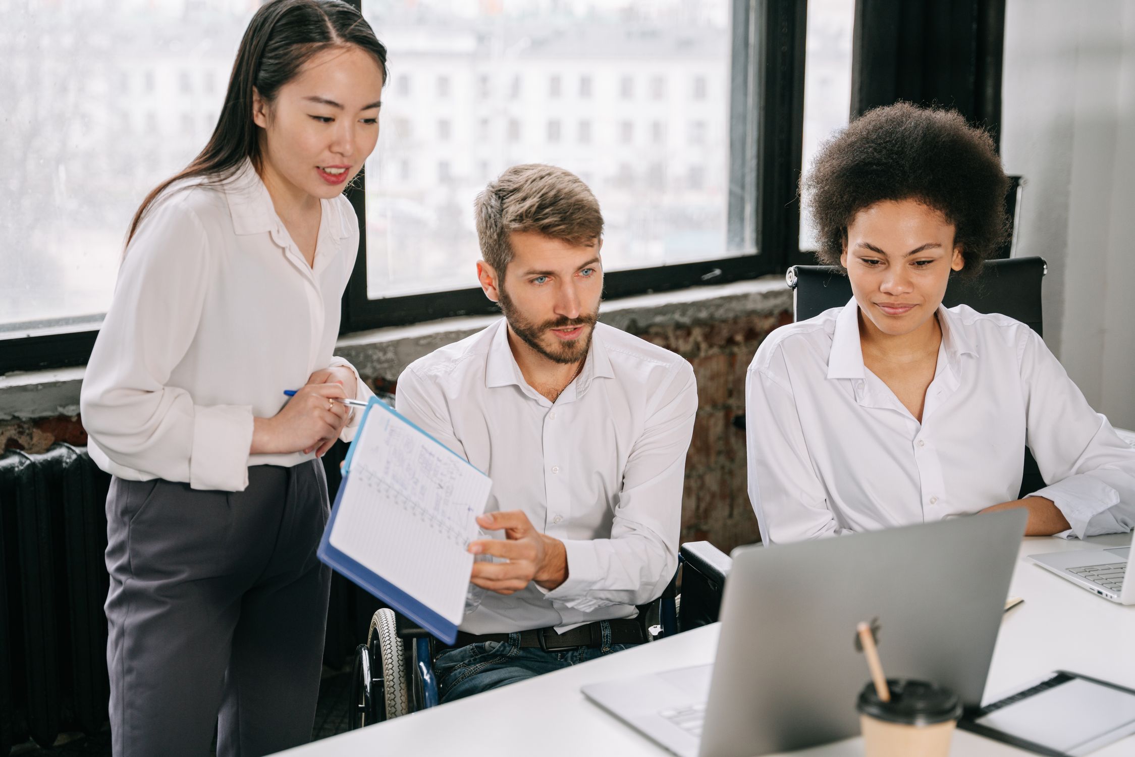 Group Presenting in Front of the Laptop · Free Stock Photo