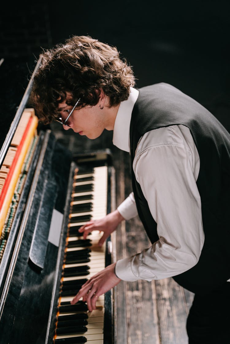 Man In Black Waistcoat Playing Piano