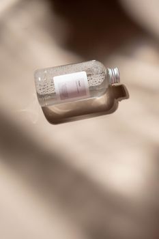 A minimalist clear cosmetic bottle casting soft shadows, perfect for skincare and beauty promotions.