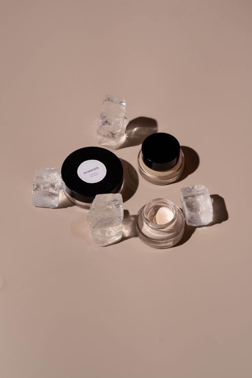 Free Still life of makeup products with ice cubes on a neutral background, offering an elegant minimalist aesthetic. Stock Photo