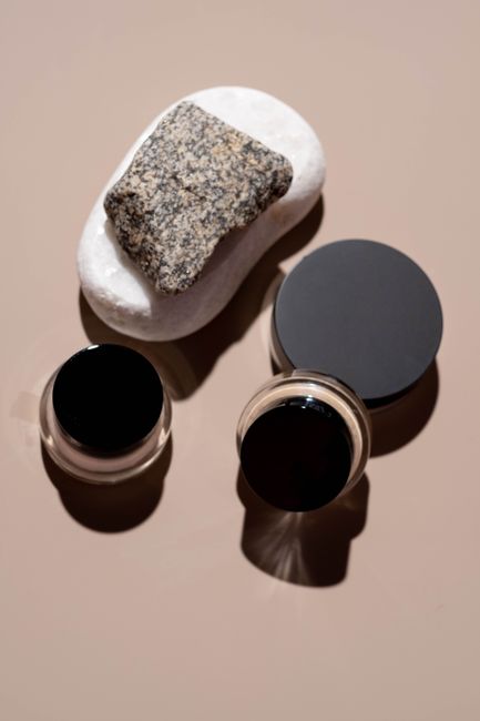 A minimalist flat lay of beauty products and rocks, emphasizing natural textures. - How to Incorporate Shilajit into Daily Routines