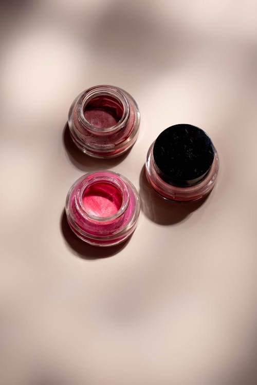 Three Red and Black Round Glass Containers