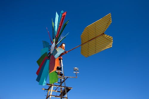 Yellow Red and Green Windmill Under Blue Sky