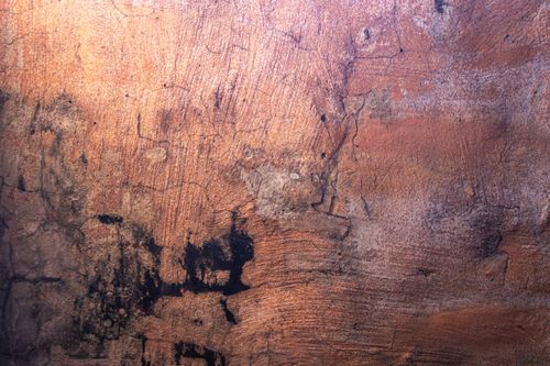 Free Close-up of a textured, rustic wall surface with visible cracks and stains. Stock Photo