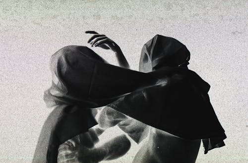 Abstract Photo of People Wearing Hoods on Head