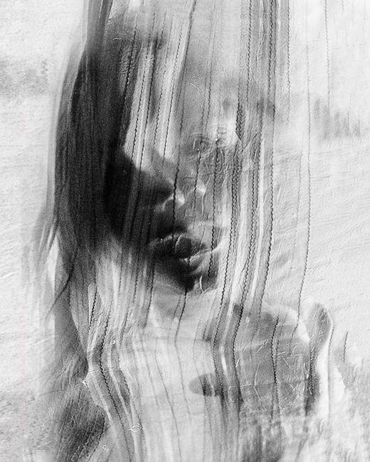 Monochrome abstract portrait with ghostly elements, creating a haunting effect.